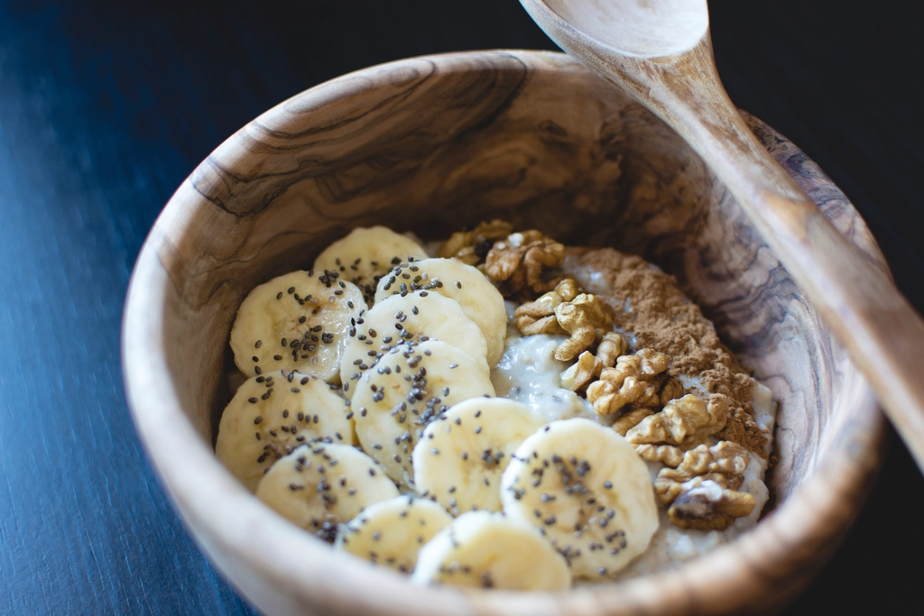 A healthy breakfast bowl of oats, banana and walnuts