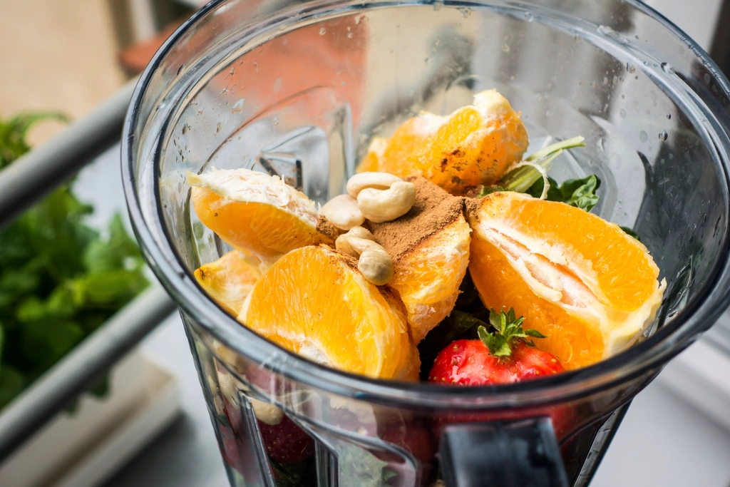 Fresh fruit and ingredients in a blender for a wellness smoothie